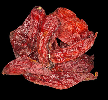 A pile of dry, red-colored chili peppers